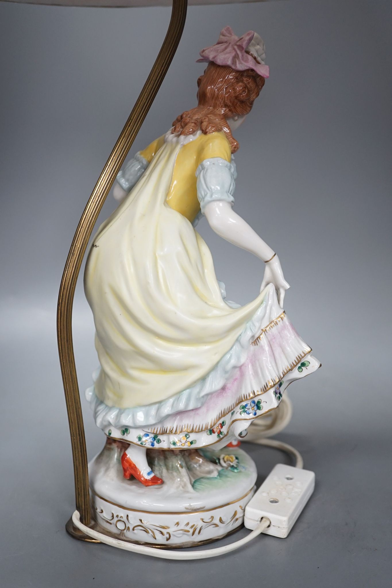 A German porcelain ‘dancing lady’ lamp, figure 29 cms high.